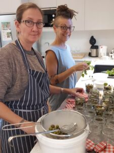 permaculture practice Michelle and Giulia in the kitchen